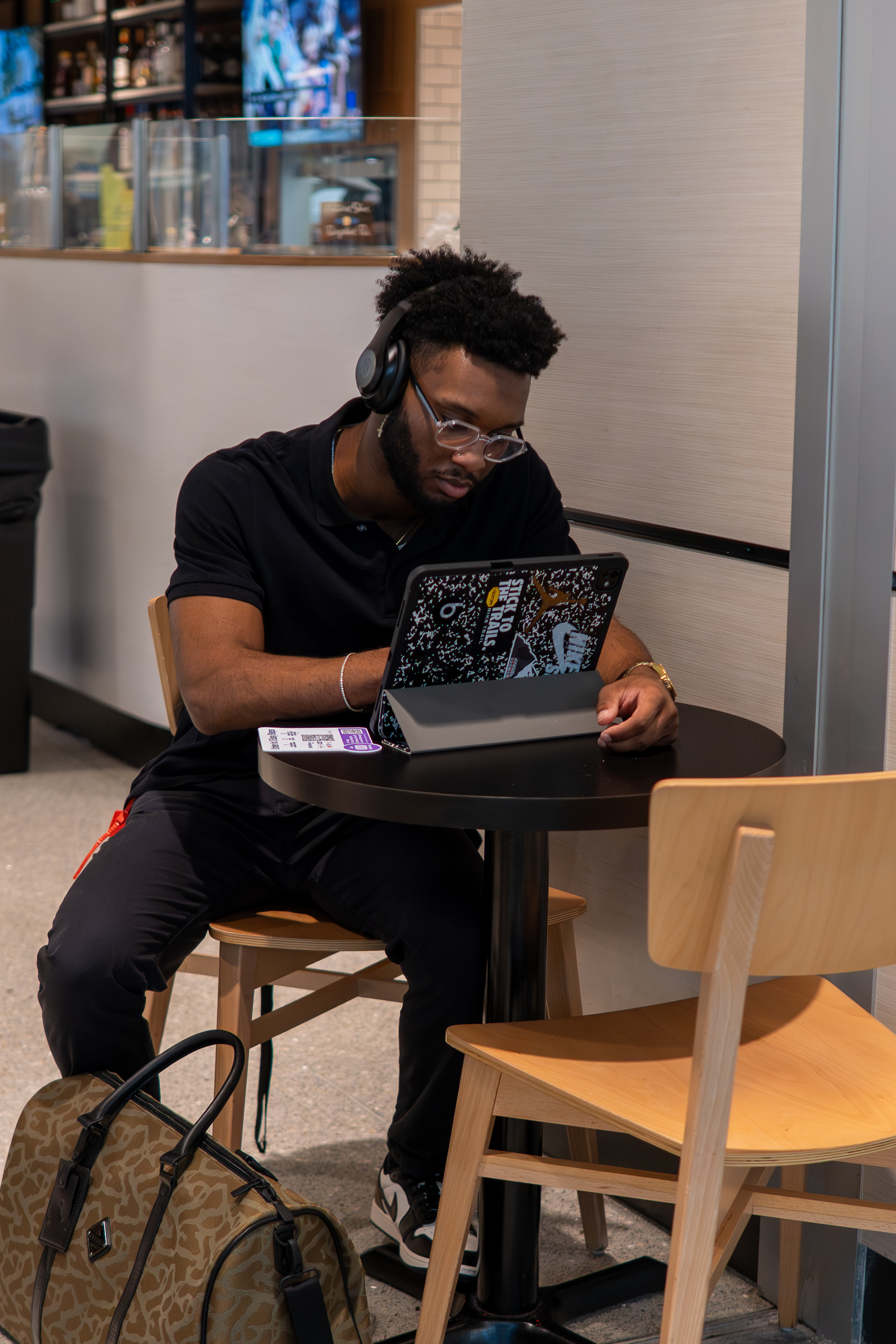 Isaiah editing at a cafe
