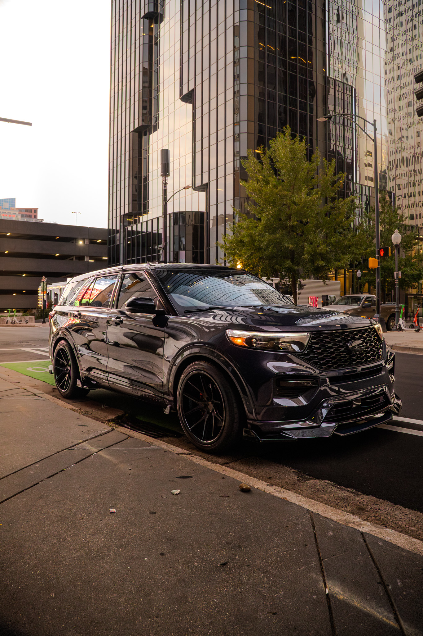 Dark Ford Explorer ST on a downtown street at blue hour