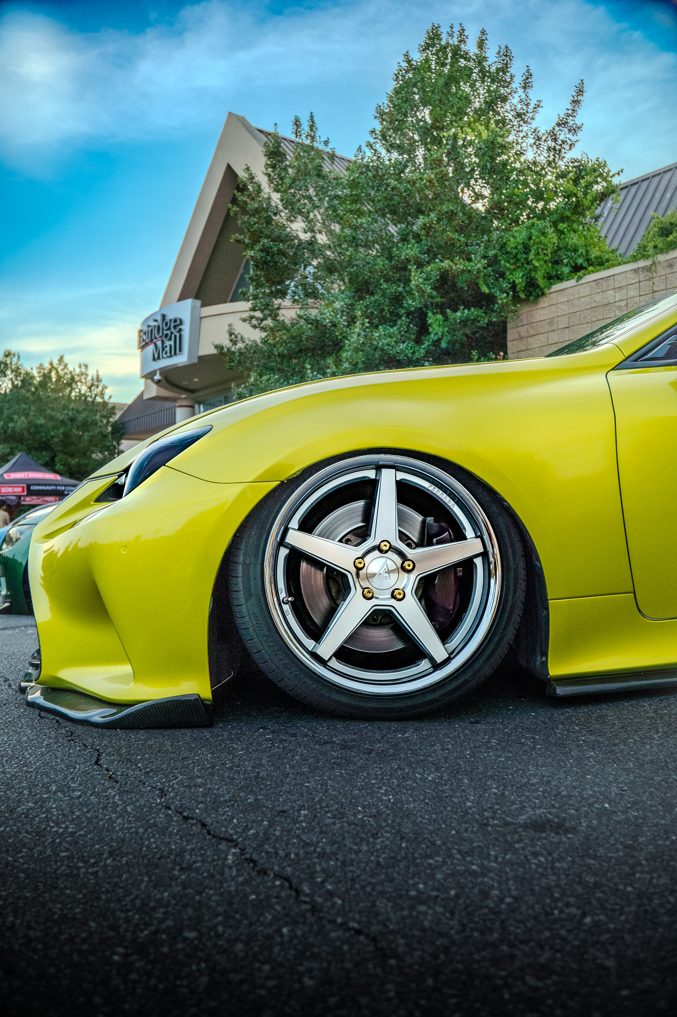 Close-up of a yellow Lexus RC's front wheel and fender