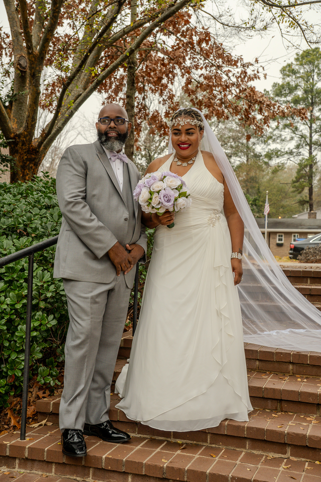 Bride and groom portrait with bouquet, smiling