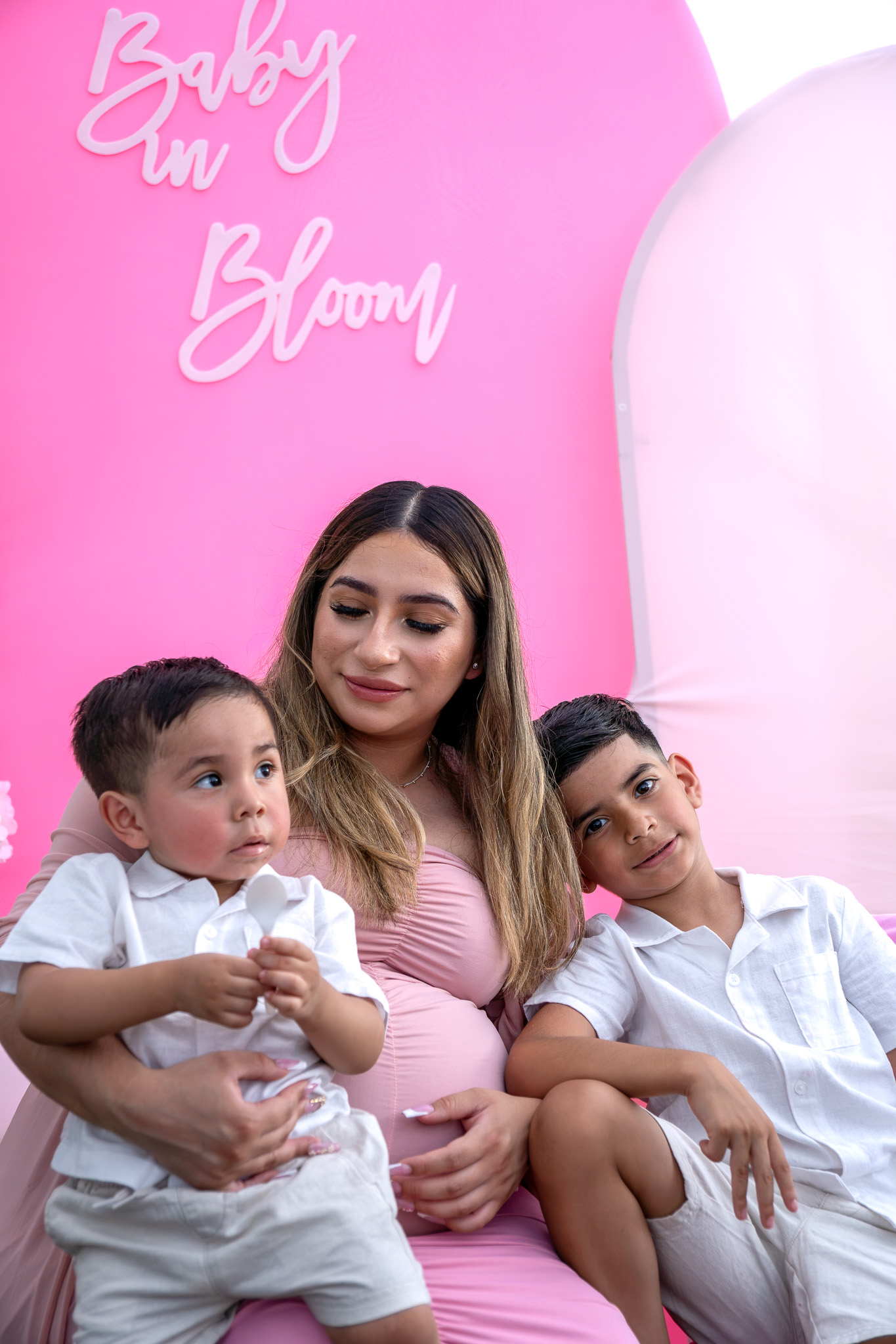 Expecting mother with her two sons at a baby shower, close crop