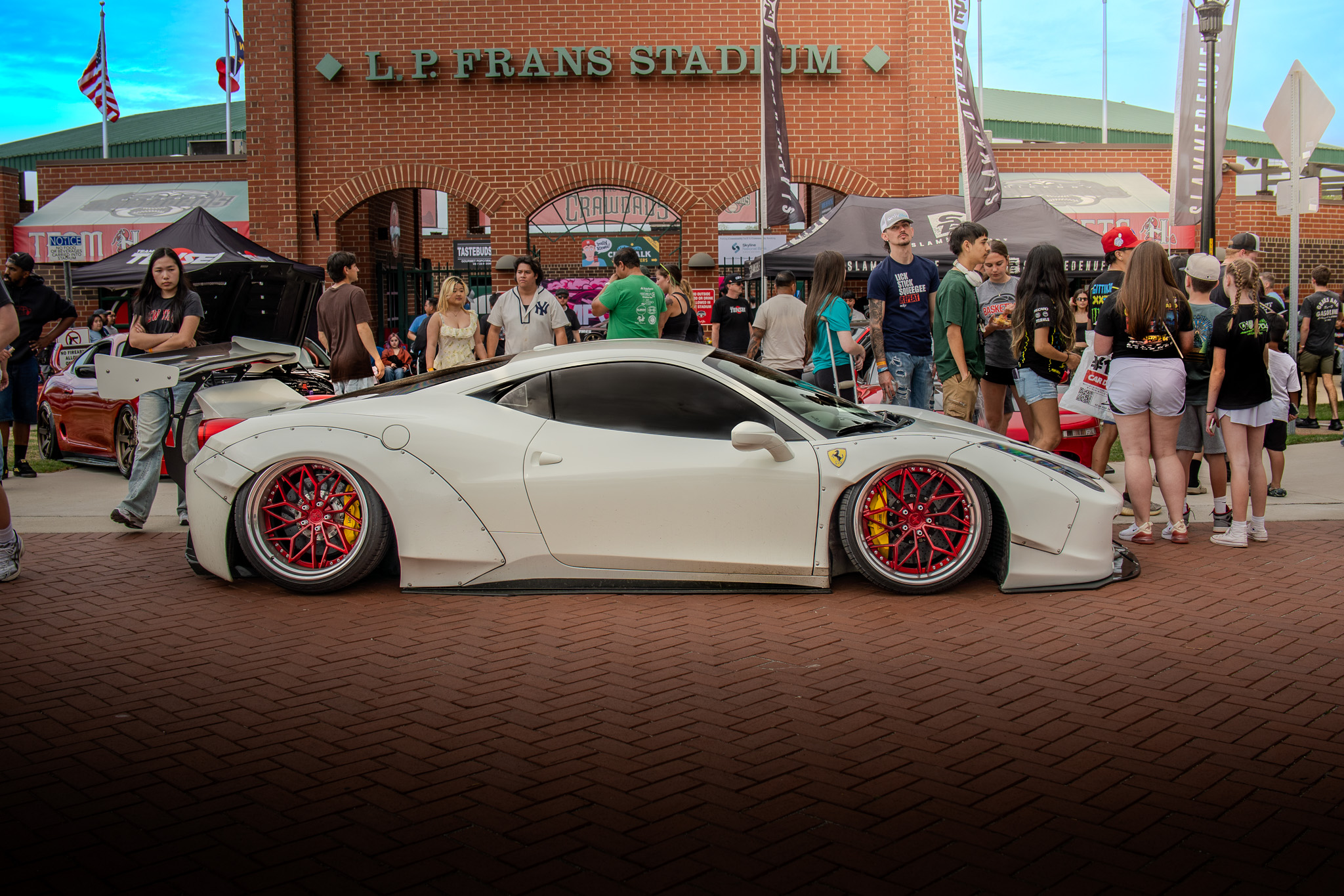 White widebody Ferrari 458 at a car show outside L.P. Frans Stadium