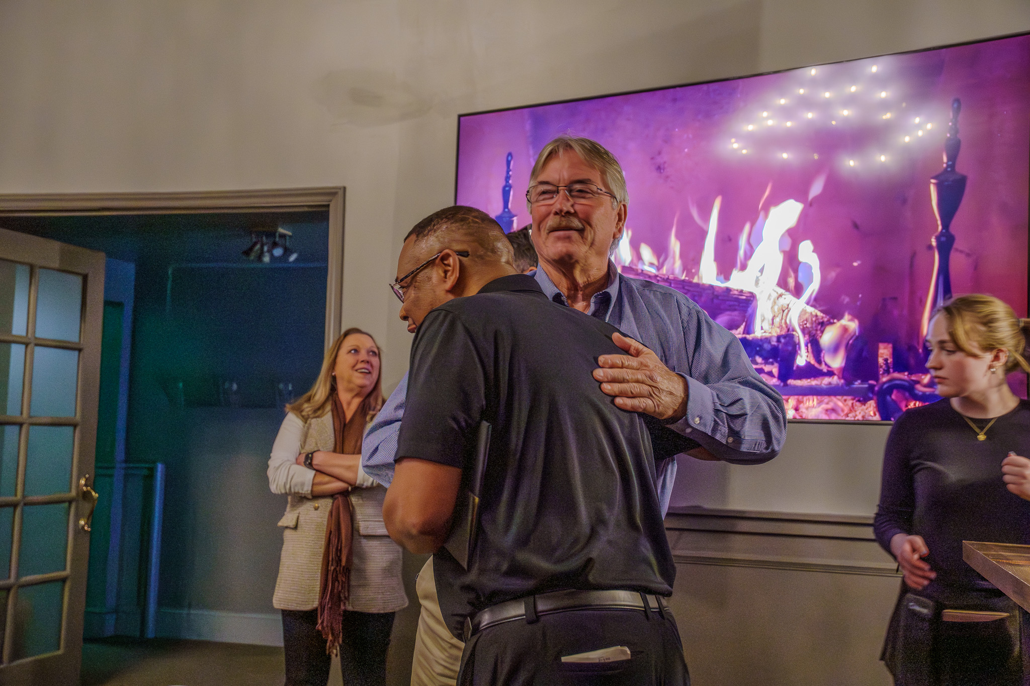 Candid hug between two colleagues at a retirement celebration