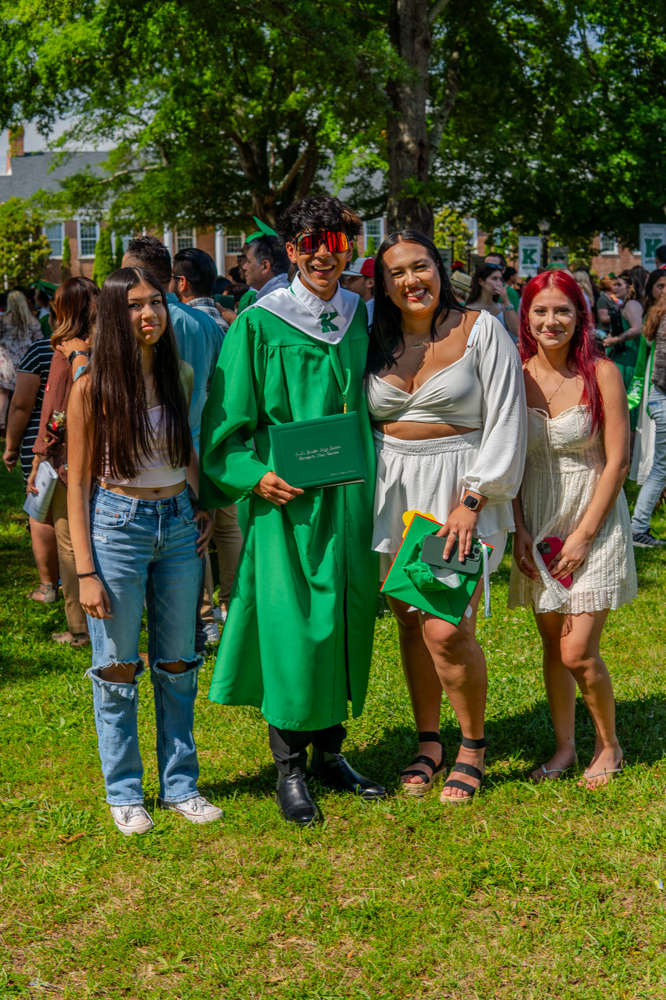 Graduate celebrating with friends on campus