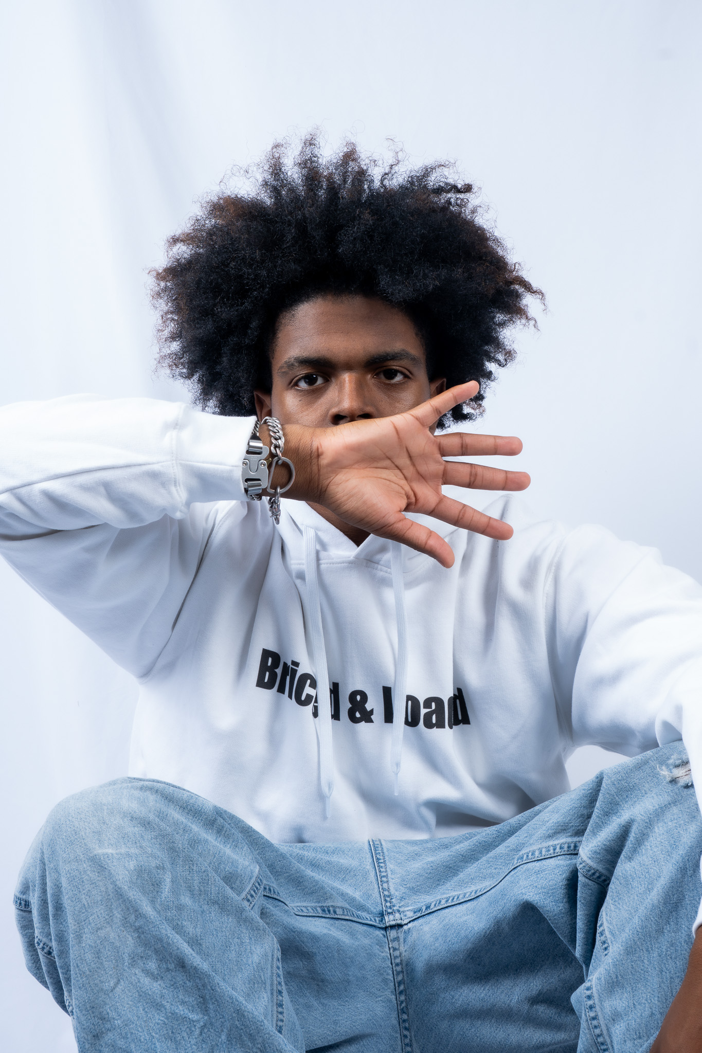 Portrait of model wearing branded hoodie for a streetwear shoot