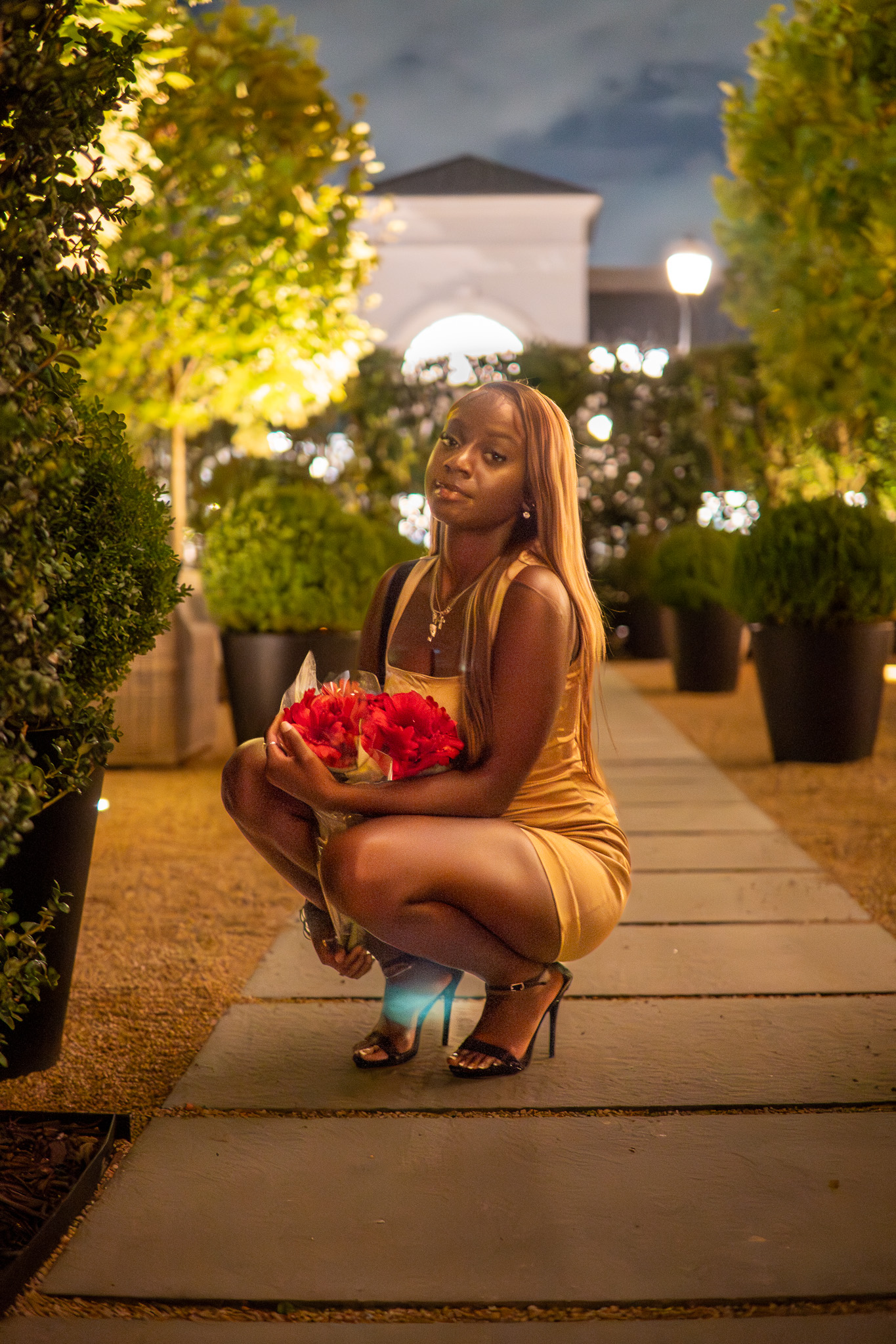 Birthday portrait session, gold dress, holding red flowers